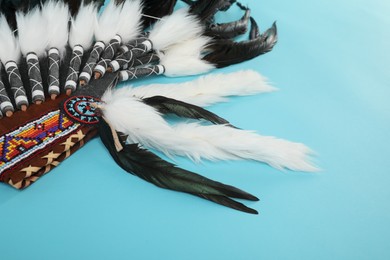 Photo of Traditional warbonnet (Native American chief headdress) on light blue background, closeup