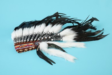 Photo of Traditional warbonnet (Native American chief headdress) on light blue background