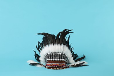 Photo of Traditional warbonnet (Native American chief headdress) on light blue background