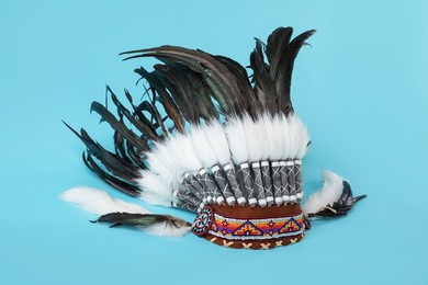 Photo of Traditional warbonnet (Native American chief headdress) on light blue background