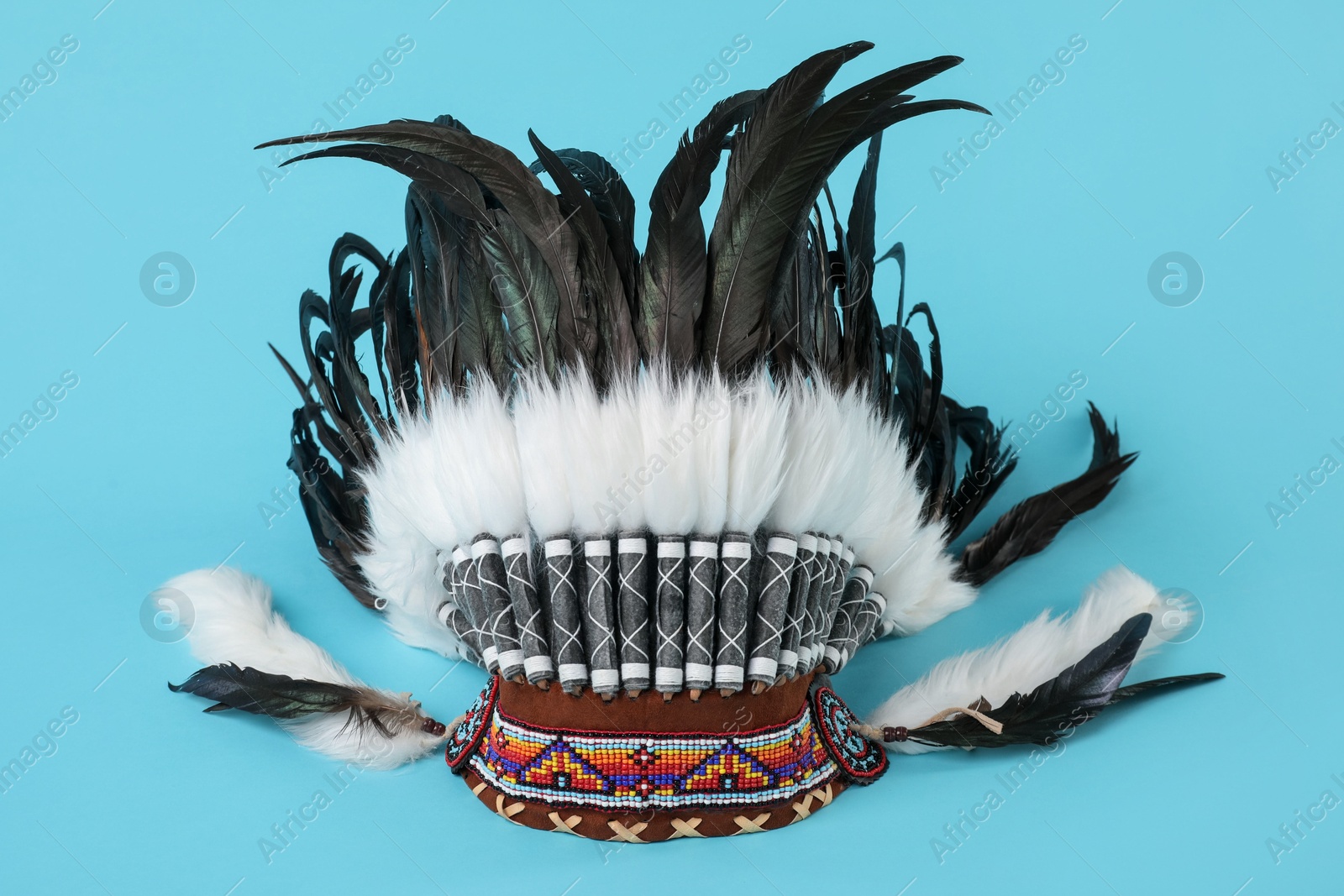 Photo of Traditional warbonnet (Native American chief headdress) on light blue background