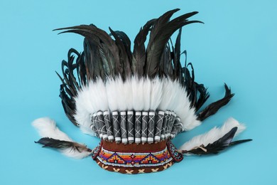 Photo of Traditional warbonnet (Native American chief headdress) on light blue background