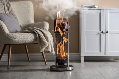 Image of Burning heater in room, flames all over device. Do not leave unattended