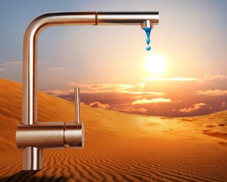 Image of Save water concept. Tap with dripping water in desert under scorching sun