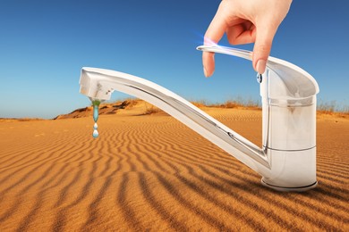 Image of Save water concept. Woman turning on or off tap in desert, closeup