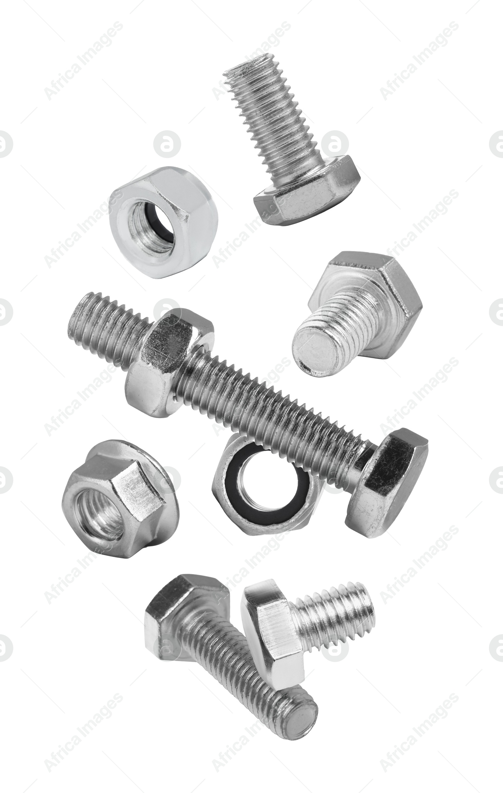 Image of Different bolts and nuts falling against white background