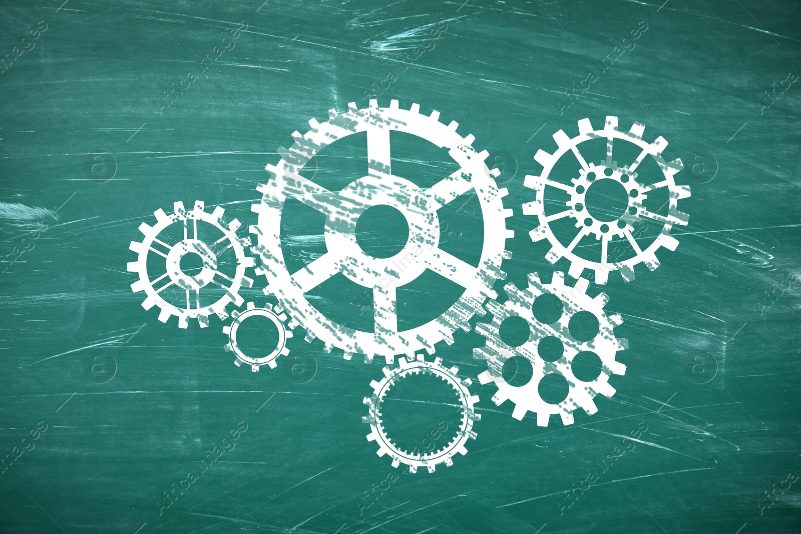 Image of Many cogwheels drawn on green chalkboard. Gear mechanism