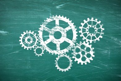 Image of Many cogwheels drawn on green chalkboard. Gear mechanism