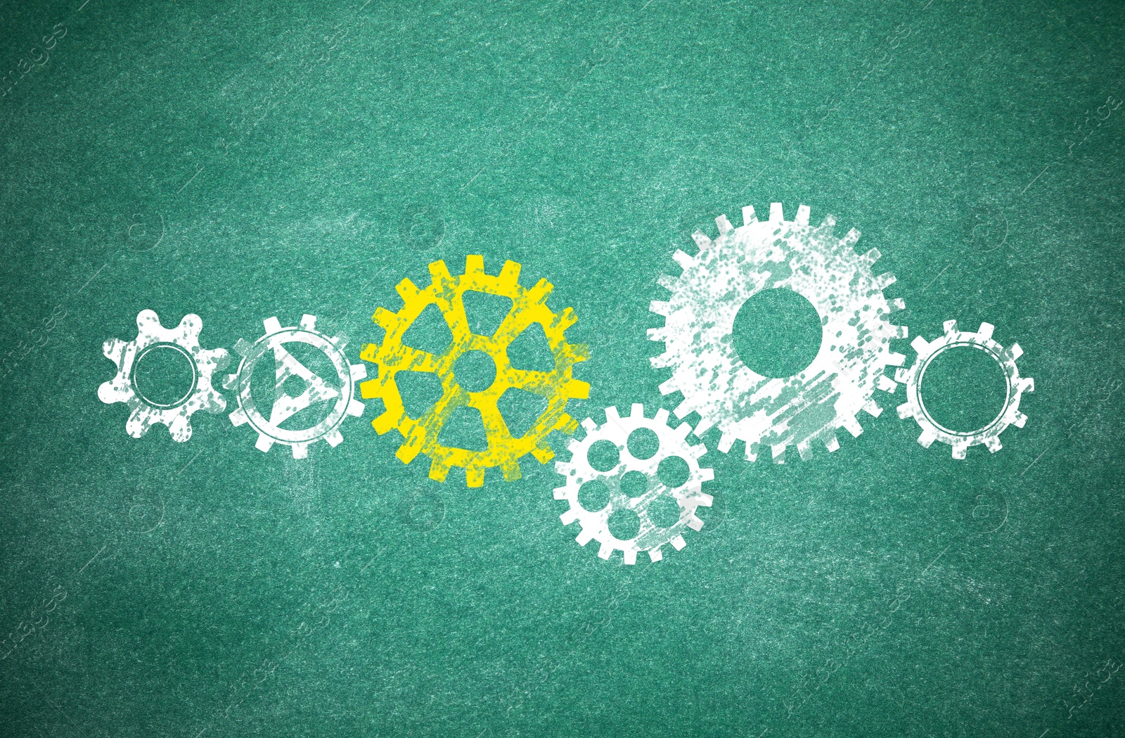 Image of Many cogwheels drawn on green chalkboard. Gear mechanism