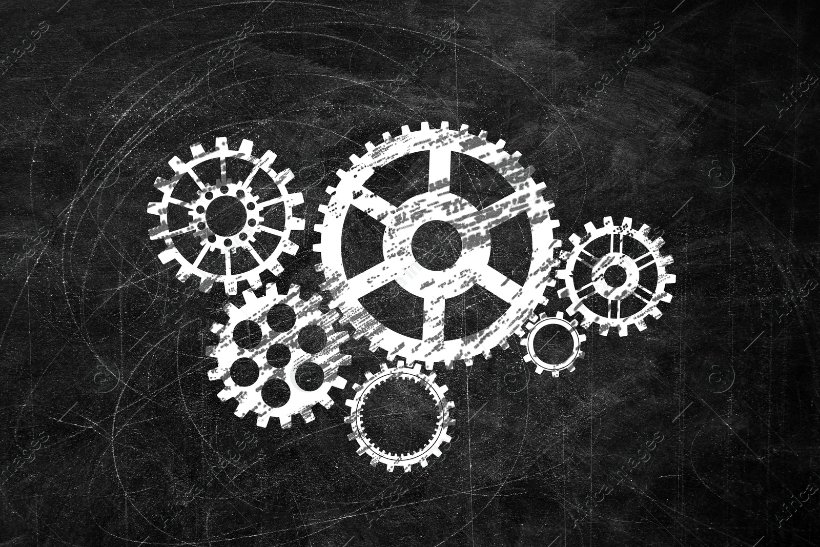 Image of Many cogwheels drawn on black chalkboard. Gear mechanism