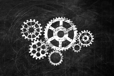 Image of Many cogwheels drawn on black chalkboard. Gear mechanism
