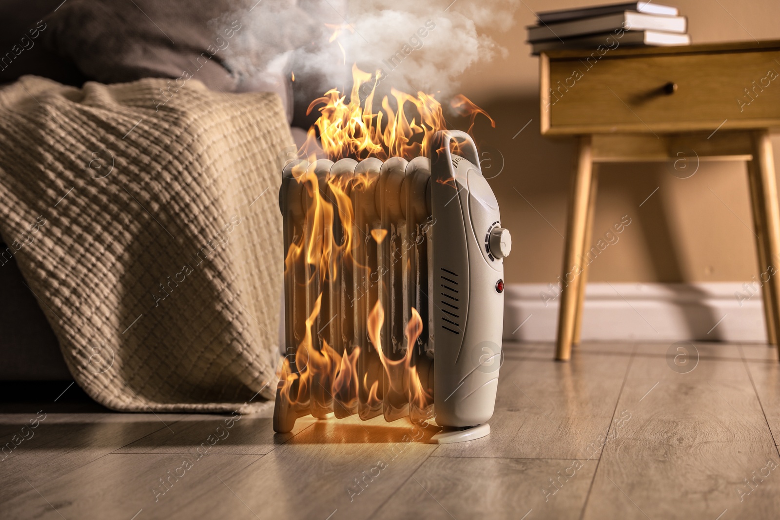 Image of Burning heater in room, flames all over device. Do not leave unattended
