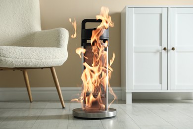 Image of Burning heater in room, flames all over device. Do not leave unattended