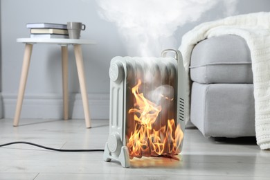 Image of Burning heater in room, flames all over device. Do not leave unattended. Dangerous accident