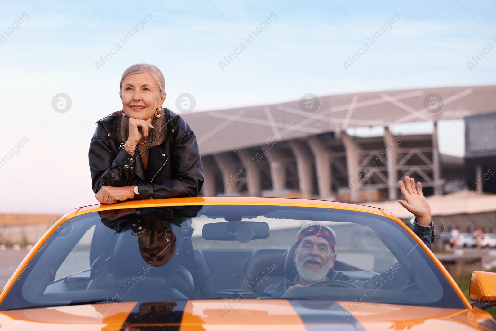 Photo of Senior couple enjoying cabriolet ride in city