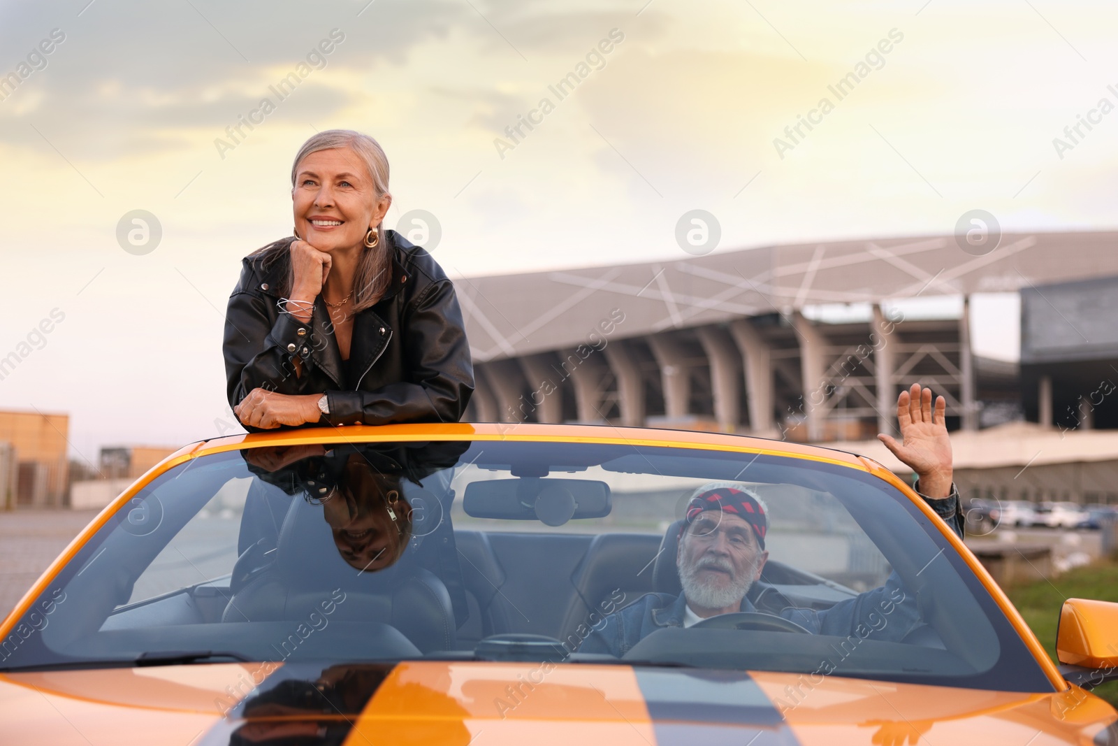 Photo of Senior couple enjoying cabriolet ride in city