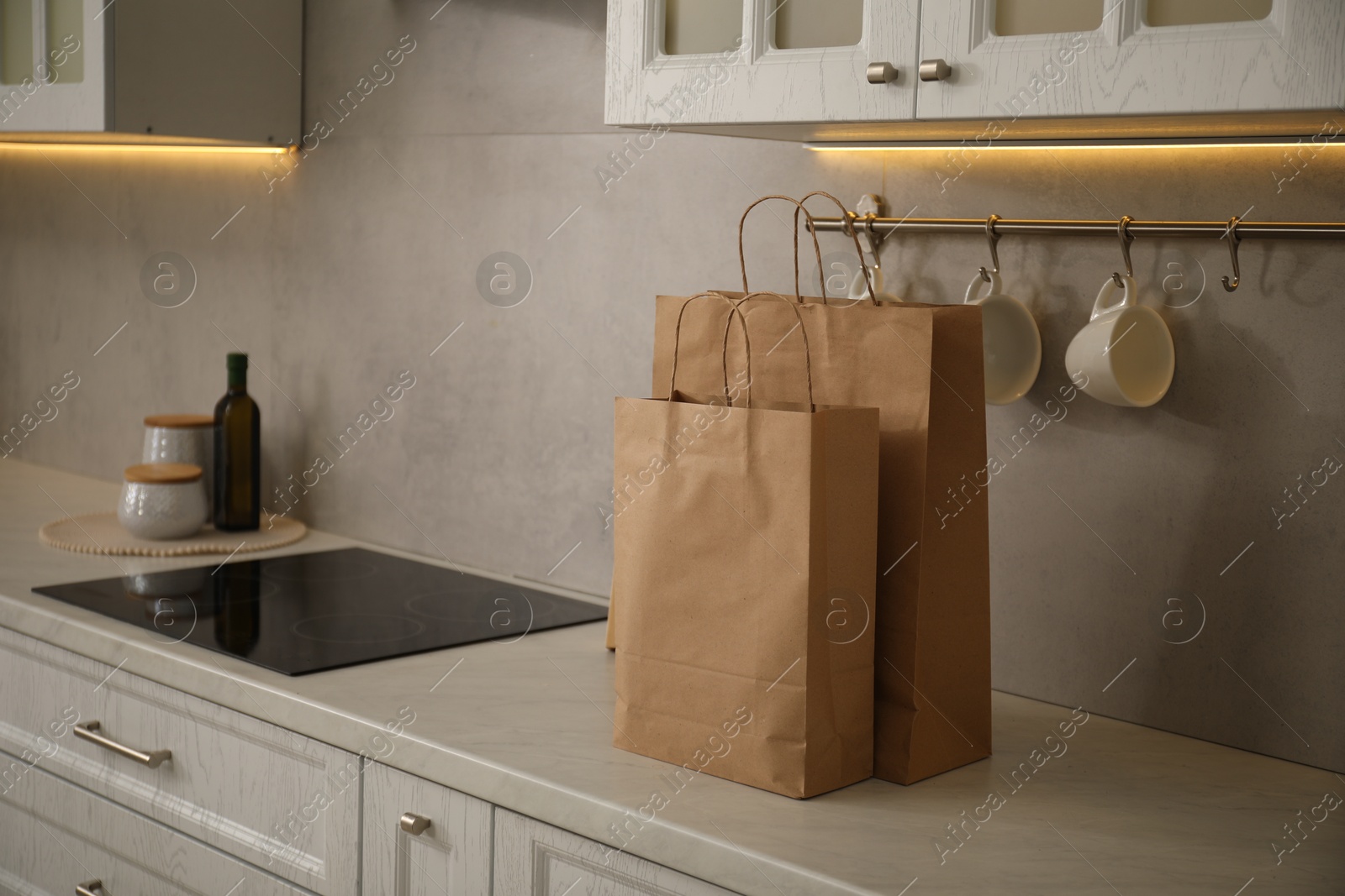 Photo of Paper bags on white counter in kitchen. Space for text