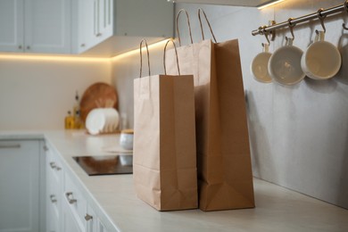 Photo of Paper bags on white counter in kitchen
