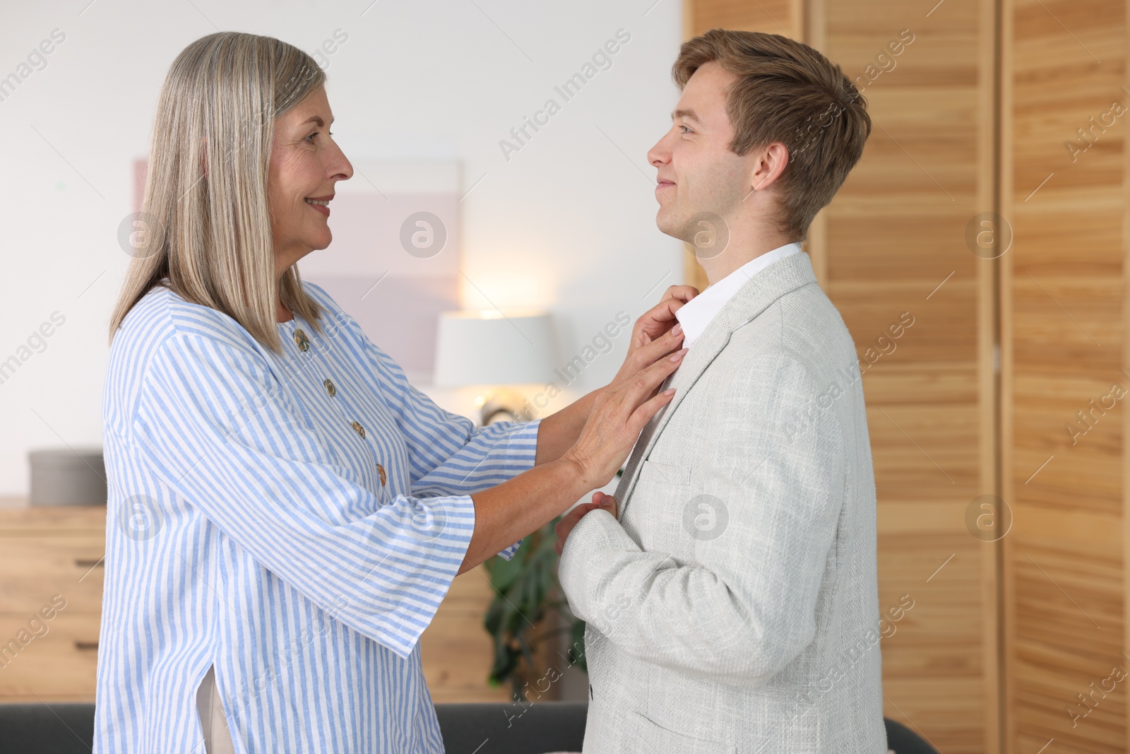 Smiling mother taking care of her son at home. Family bonding Photo of Smiling mother taking care of her son at home. Family bonding