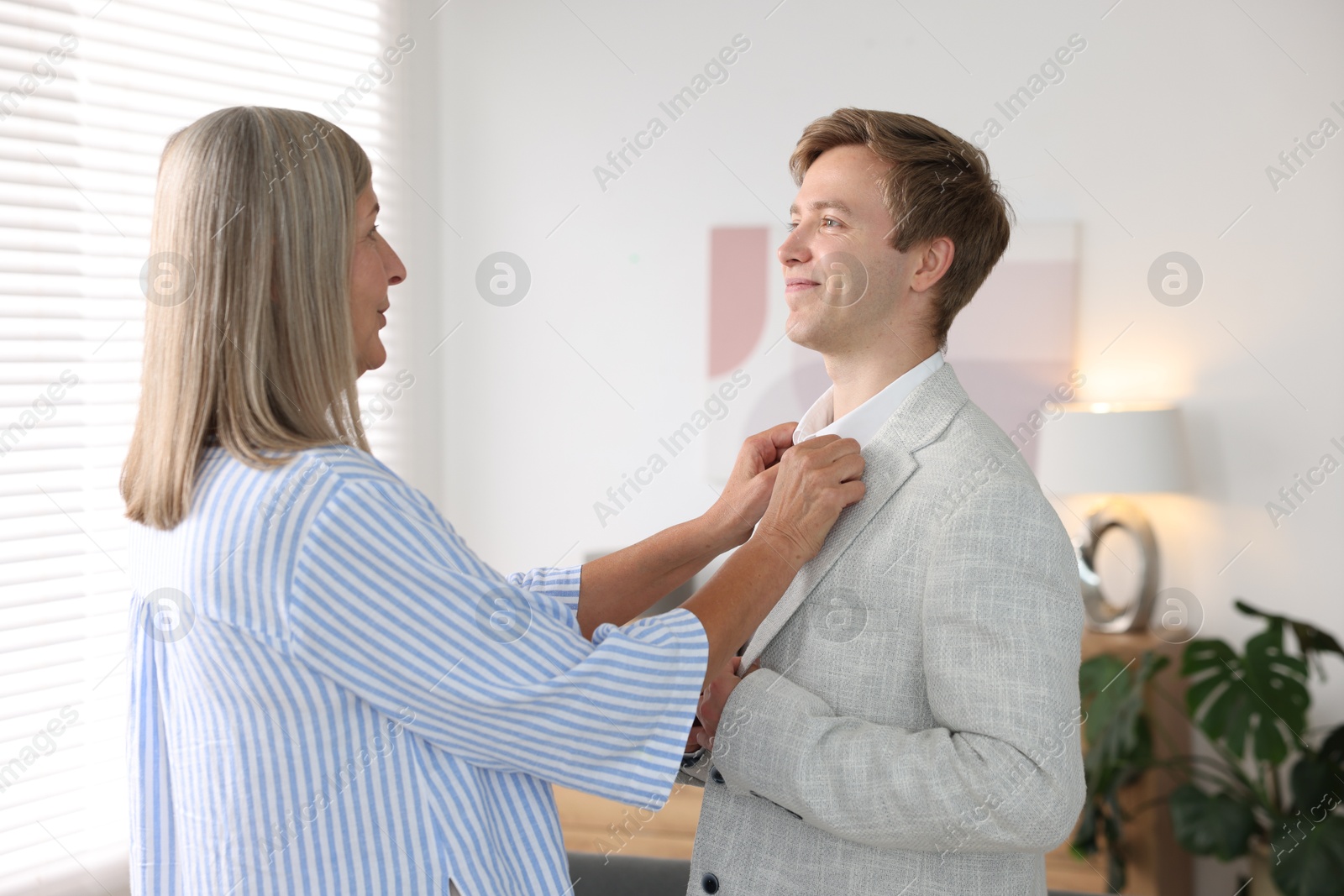 Photo of Mother taking care of her son at home. Family bonding