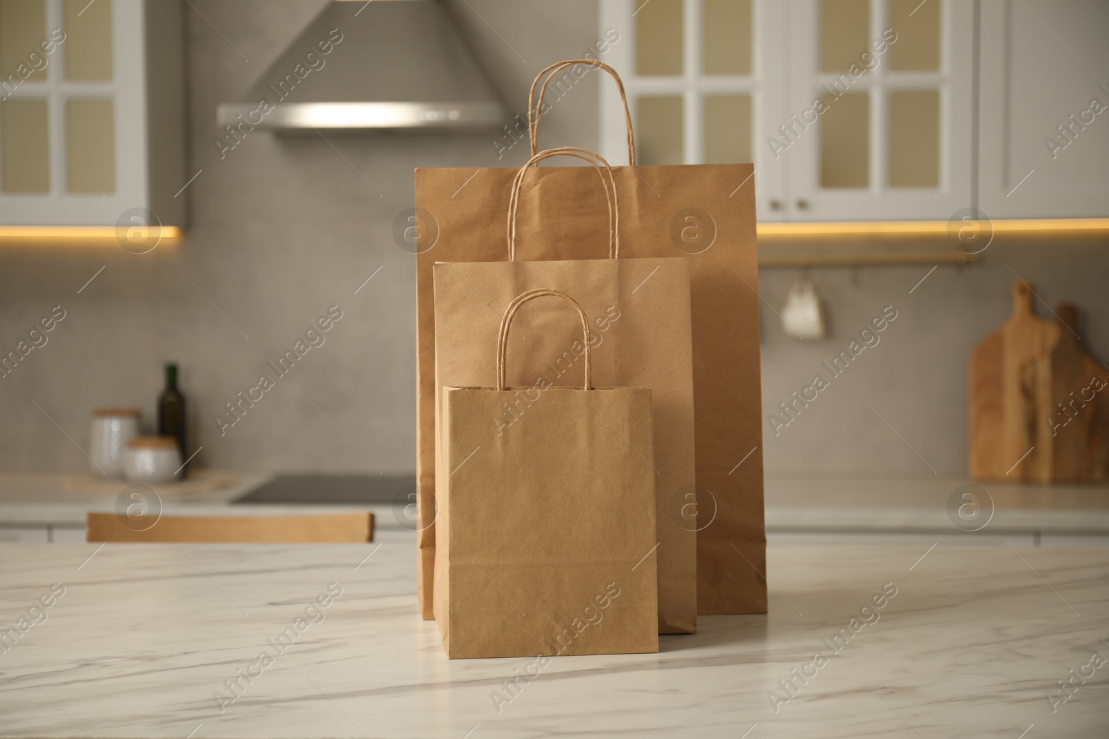 Photo of Paper bags on white marble table in kitchen