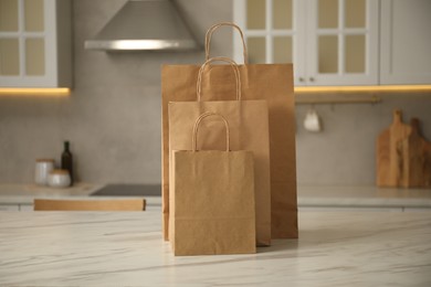 Photo of Paper bags on white marble table in kitchen