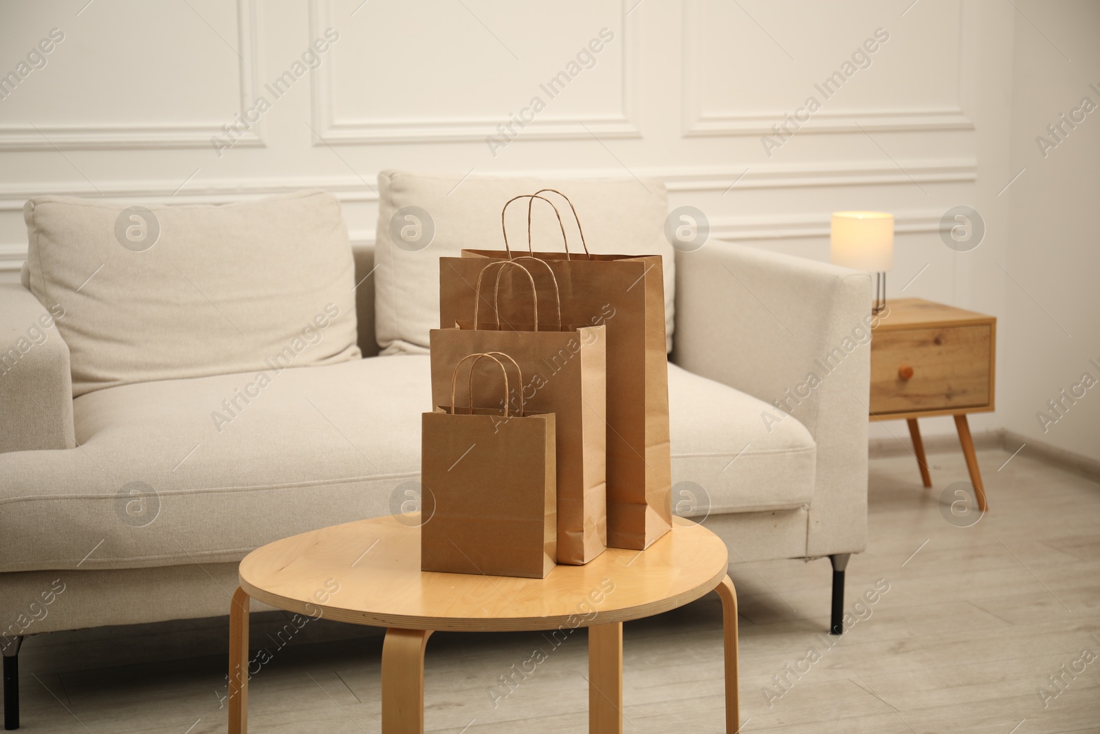 Photo of Paper bags on wooden table at home