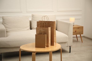 Photo of Paper bags on wooden table at home