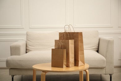 Photo of Paper bags on wooden table at home