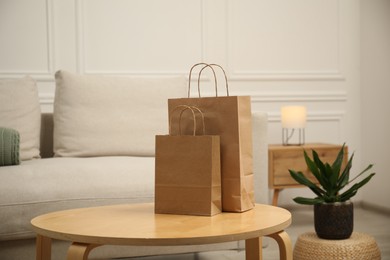 Photo of Paper bags on wooden table at home