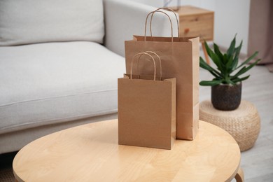 Photo of Paper bags on wooden table at home