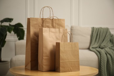 Photo of Paper bags on wooden table at home
