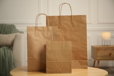 Photo of Paper bags on wooden table at home