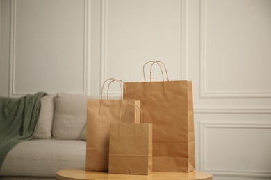 Photo of Paper bags on wooden table at home