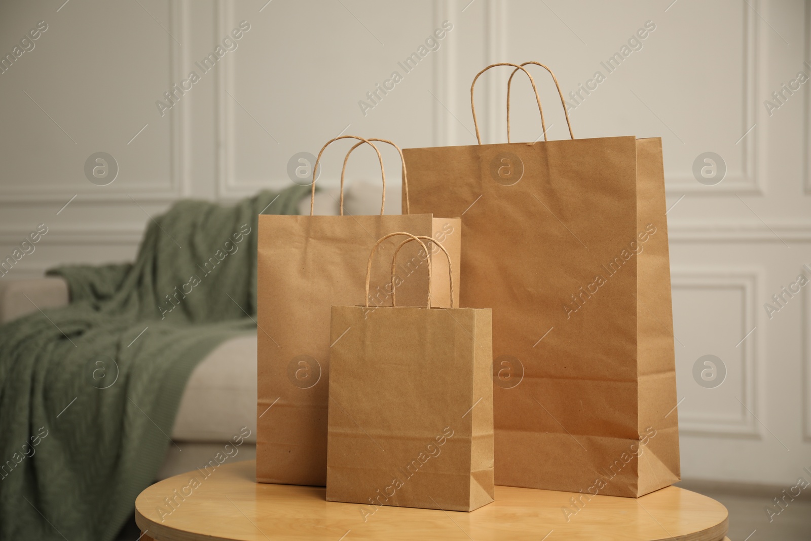 Paper bags on wooden table at home Photo of Paper bags on wooden table at home