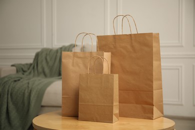 Photo of Paper bags on wooden table at home