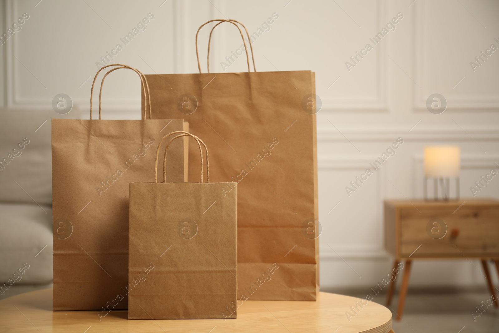 Photo of Paper bags on wooden table at home