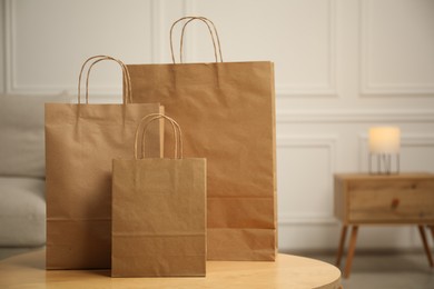 Photo of Paper bags on wooden table at home