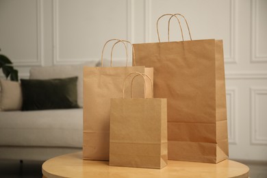 Photo of Paper bags on wooden table at home