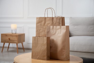 Photo of Paper bags on wooden table at home