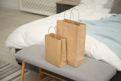 Photo of Paper bags on bench near bed at home
