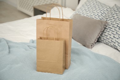 Photo of Paper shopping bags on bed at home