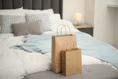 Photo of Paper shopping bags on bed at home