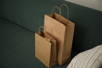 Photo of Paper shopping bags on sofa at home