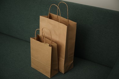 Photo of Paper shopping bags on sofa at home