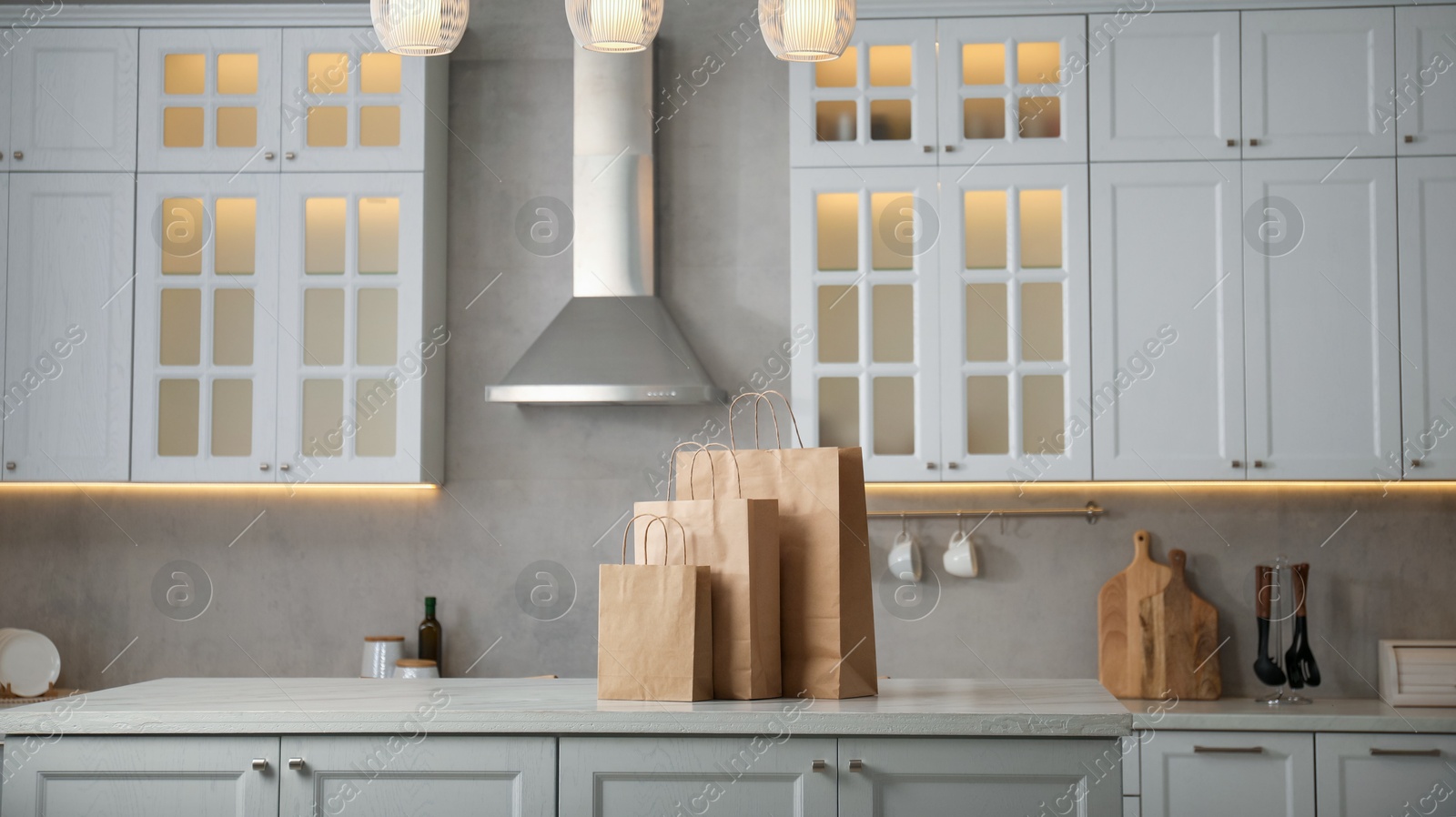Paper bags on white marble table in kitchen. Space for text Photo of Paper bags on white marble table in kitchen. Space for text