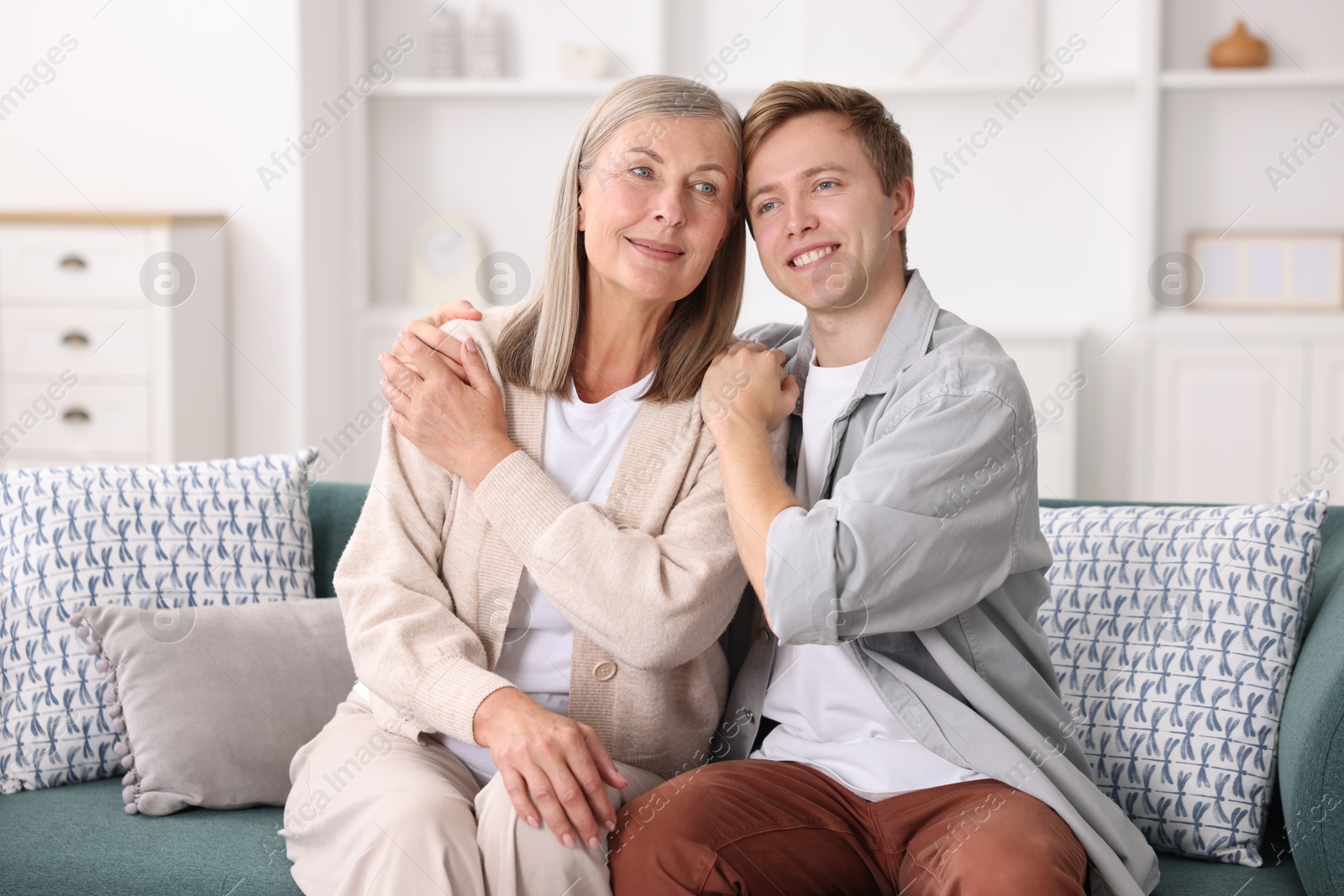 Happy son and his mother on sofa at home Photo of Happy son and his mother on sofa at home