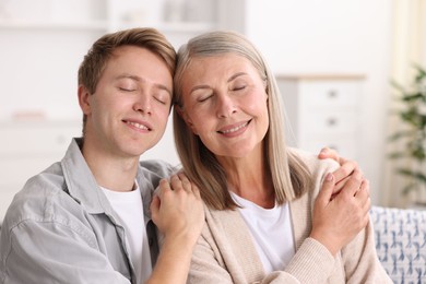 Photo of Happy son and his mother at home. Family bonding