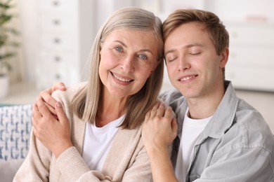 Photo of Happy son and his mother at home. Family bonding