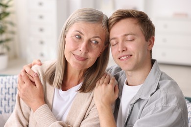 Photo of Happy son and his mother at home. Family bonding